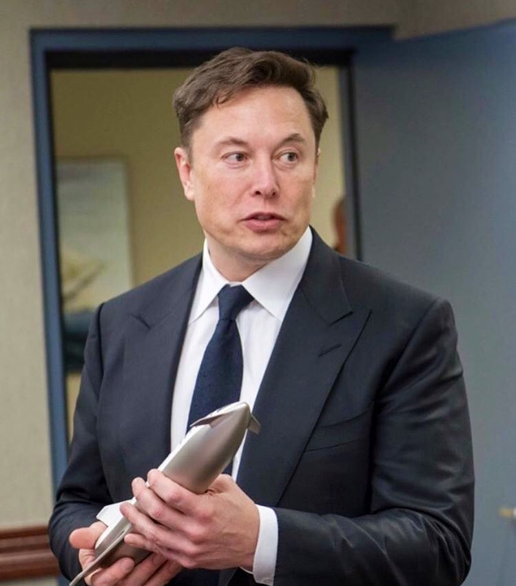 Elon Musk with a Model of Starship