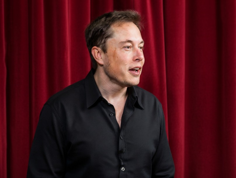 Young Elon Musk speaking at Stanford in 2003 – Rare close-up from his first documented public talk" 32-year-old Elon Musk during his October 8, 2003 Entrepreneurial Thought Leaders lecture at Stanford. This historical moment captures Elon shortly after selling PayPal, with SpaceX still in its earliest days. Image enhanced for clarity using Grok Imagine.