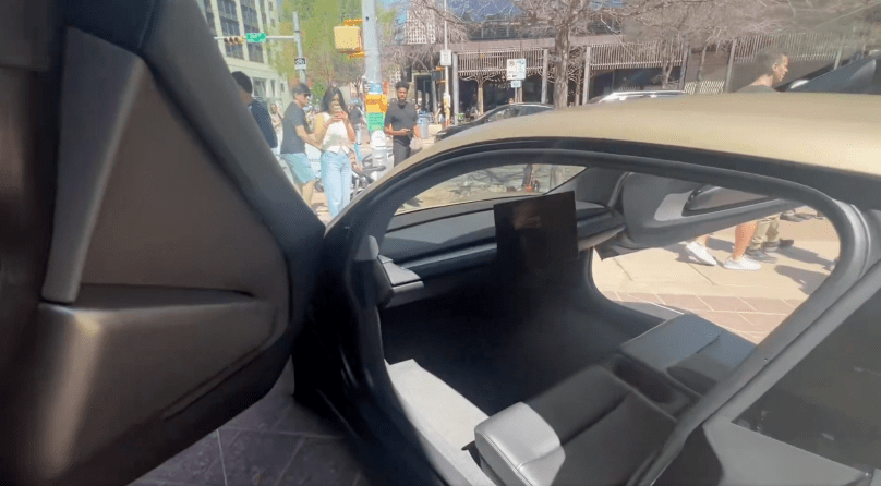 Tesla Cybercab Robotaxi open door view during Gail’s autonomous ride to SXSW in Austin, Texas. Real-world FSD in action – spacious interior and sunny downtown streets captured in Episode 164 of Gail’s Tesla Podcast.