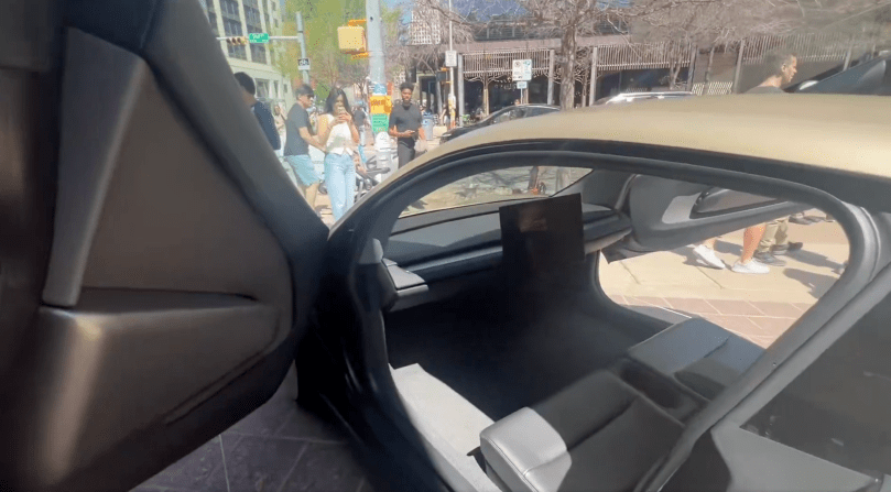 Tesla Cybercab Robotaxi open door view during Gail’s autonomous ride to SXSW in Austin, Texas. Real-world FSD in action – spacious interior and sunny downtown streets captured in Episode 164 of Gail’s Tesla Podcast.